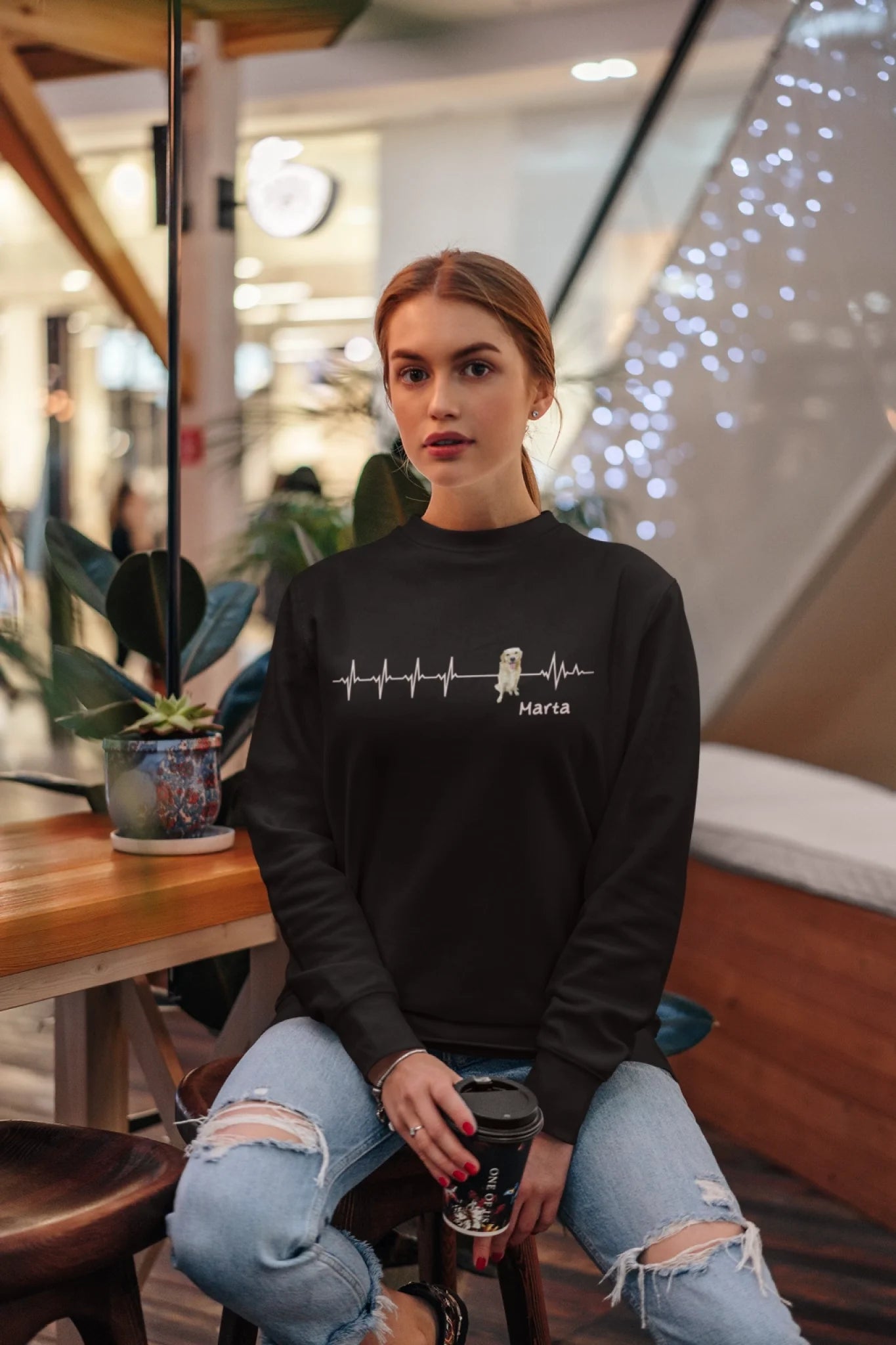 crewneck-sweatshirt-mockup-featuring-a-woman-sitting-at-a-restaurant-5299-el1