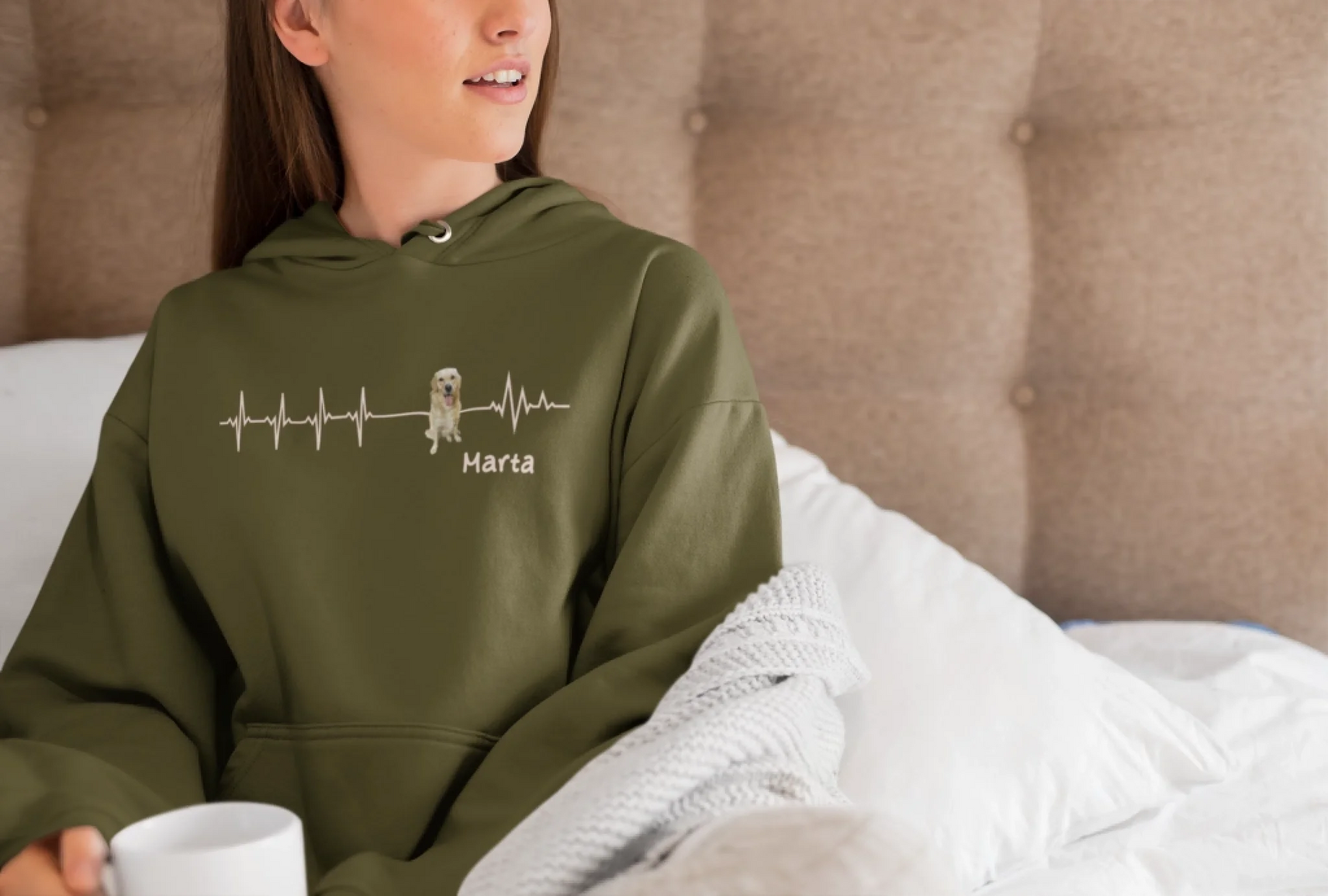 pullover-hoodie-mockup-of-a-young-woman-sitting-on-a-bed-with-a-coffee-mug-23212